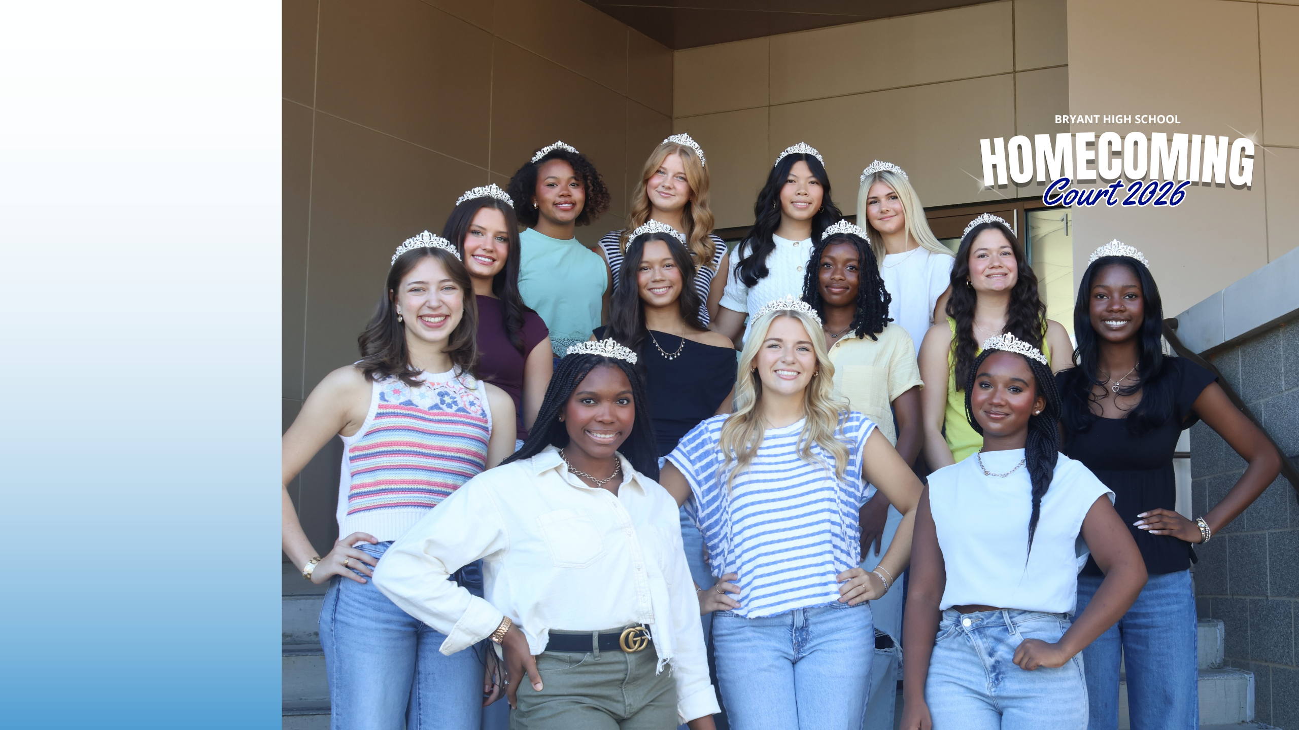 A group of young women, wearing crowns, stand in front of a building. Some wear jeans, others tank tops.