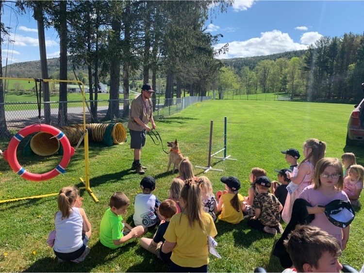 students learning from a dog trainer