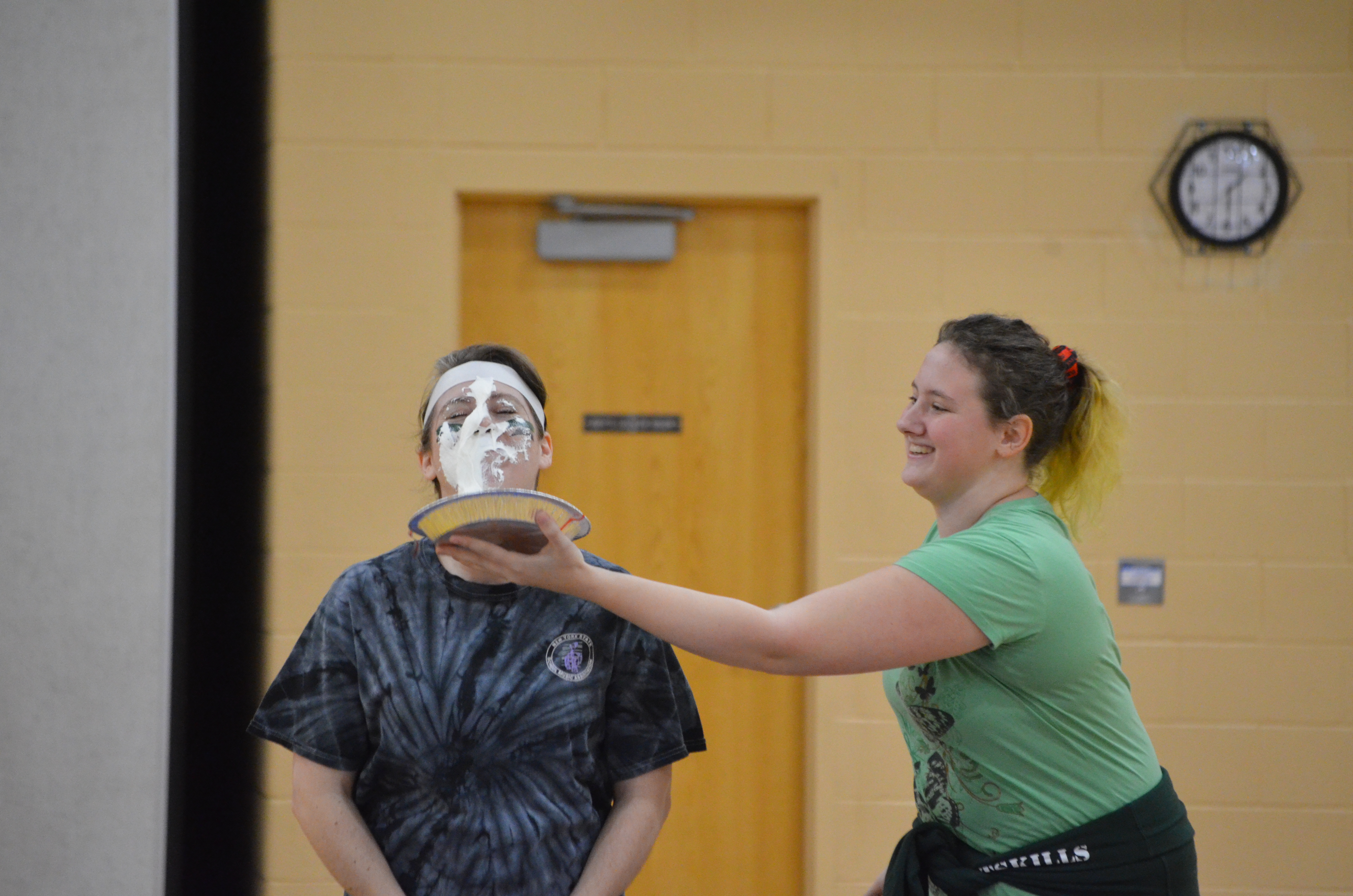 teacher pie-ing another teacher in the face