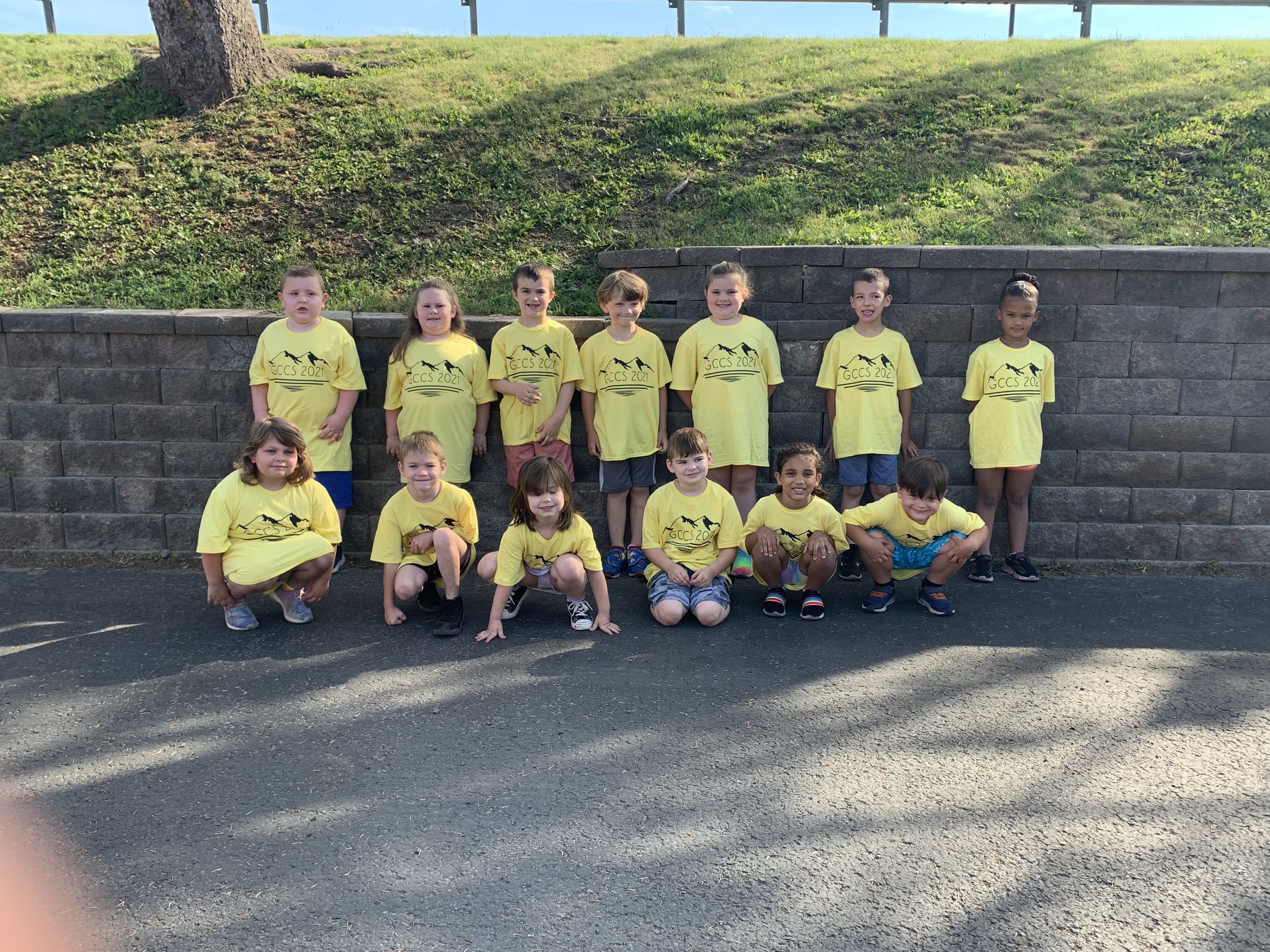 young students standing together in matching tshirts