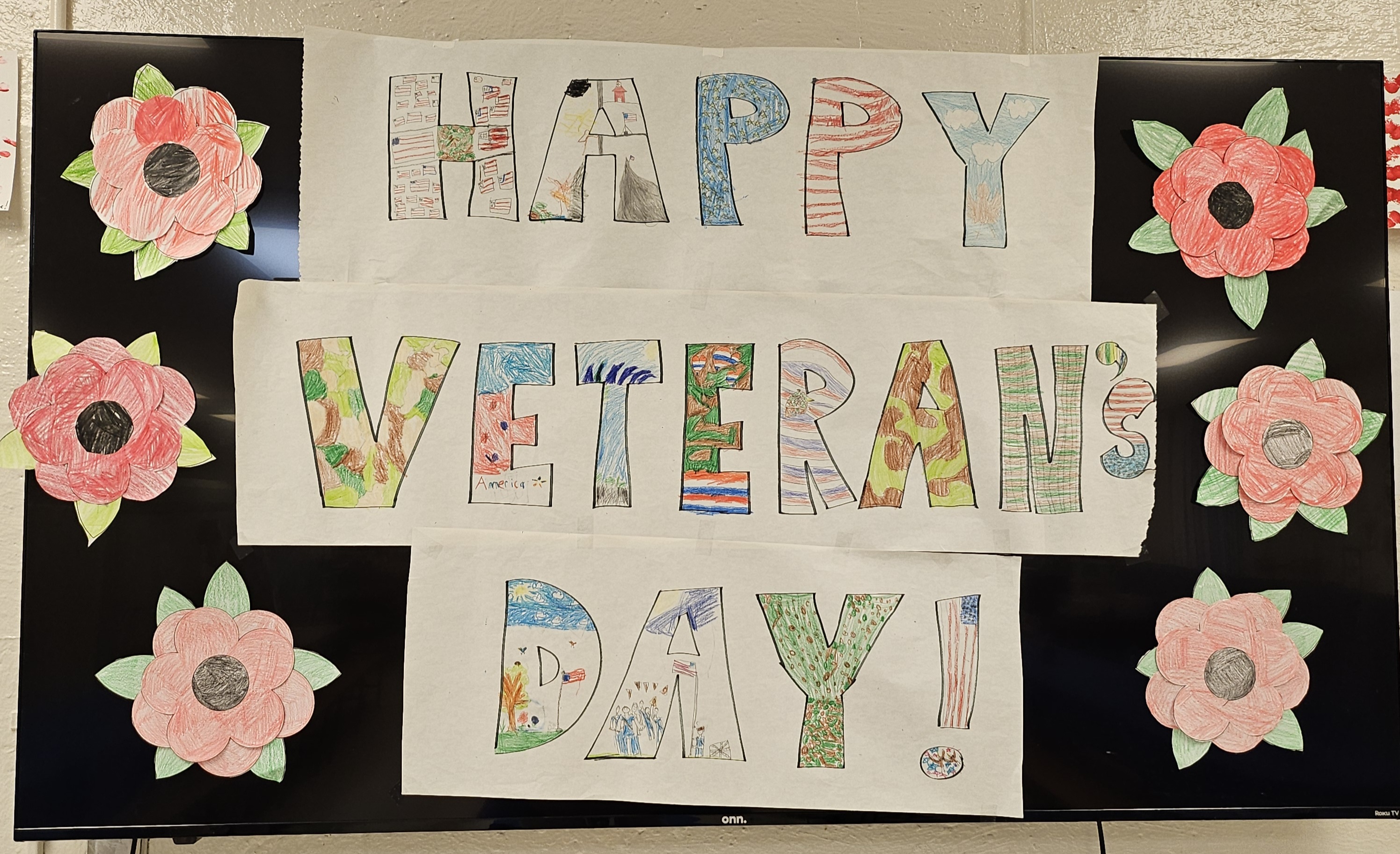 Happy Veteran's Day sign made by students