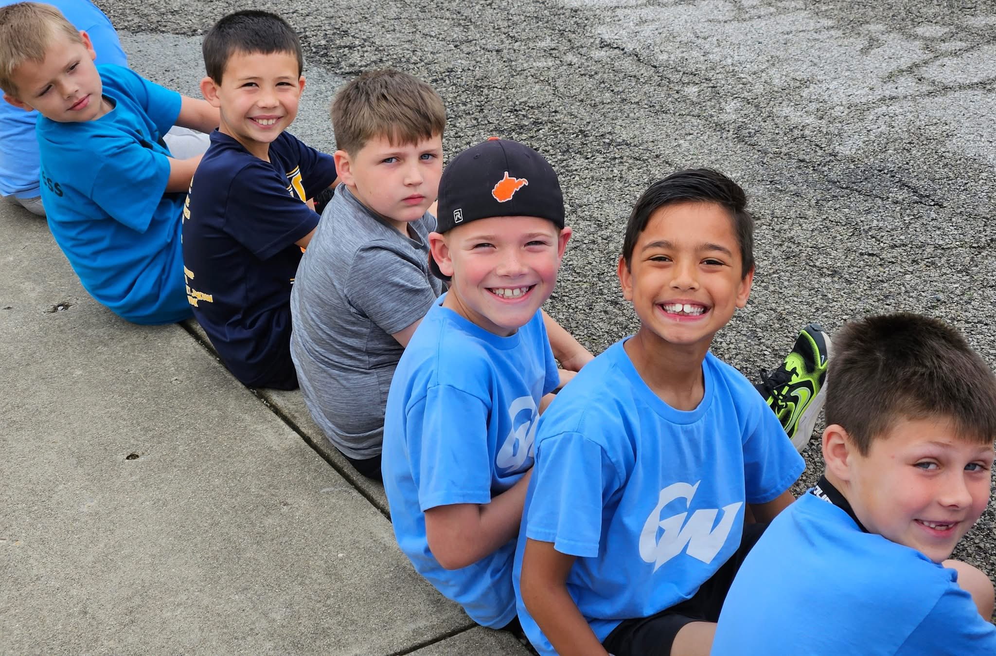 Students sitting and smiling at field day