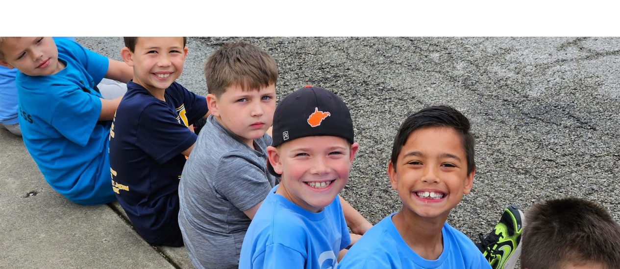 Students sitting and smiling at field day