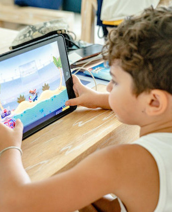 boy using learning game on ipad