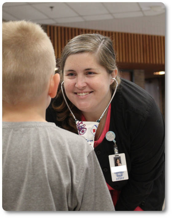 nurse smiling at young child