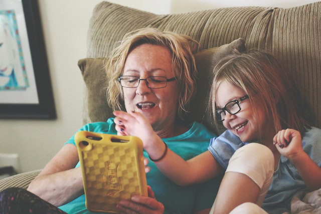 grandmother and grand daughter using tablet