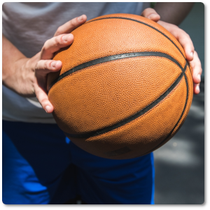 teen holding a basketball up close