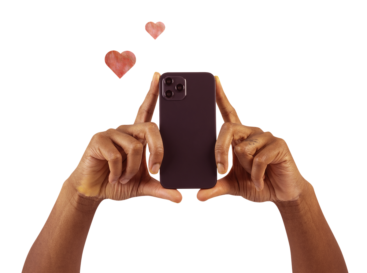 hands holding up a cell phone as if recording - two random hearts in background