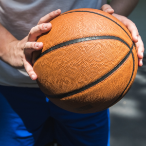 teen holding a basketball up close