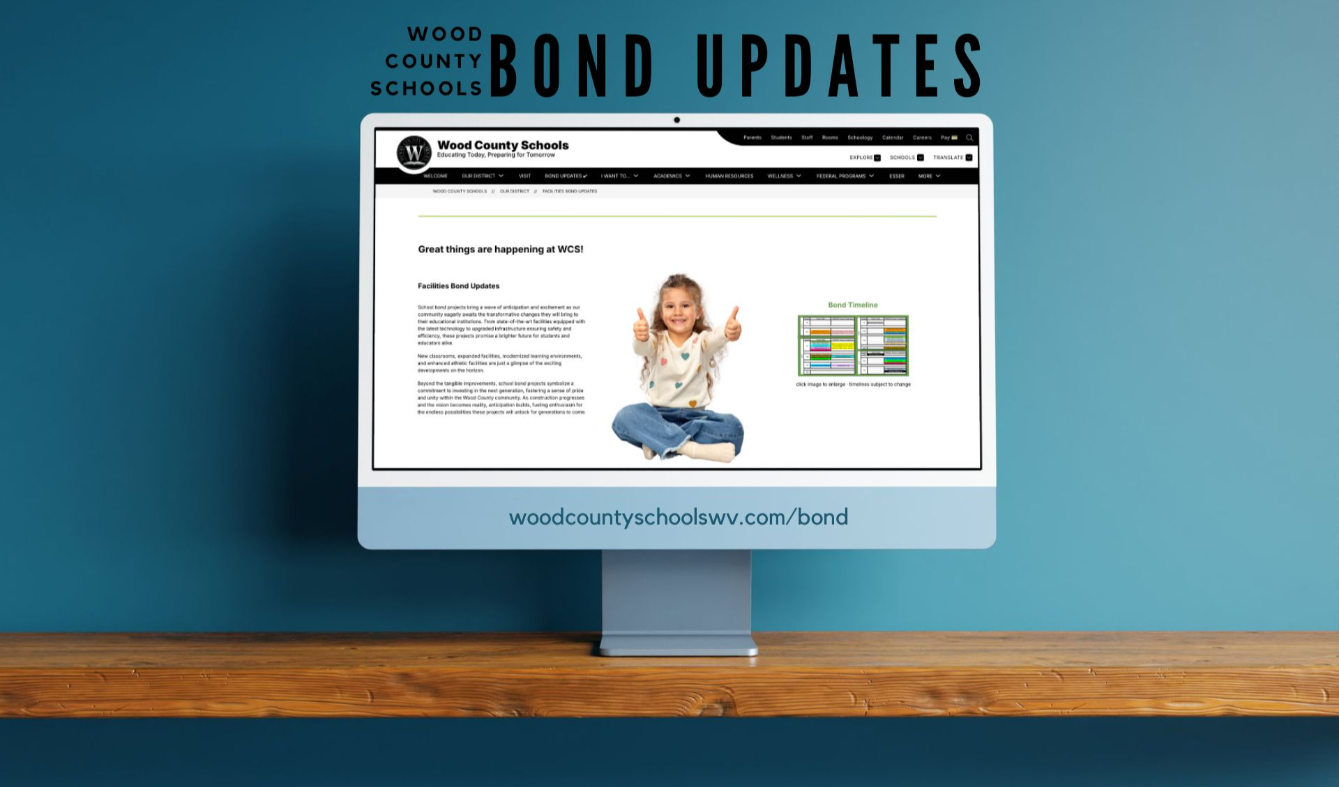 image of an iMac with the Wood County Schools Bond Updates webpage on the screen. There is a teal blue background and the computer is placed on a wooden shelf.