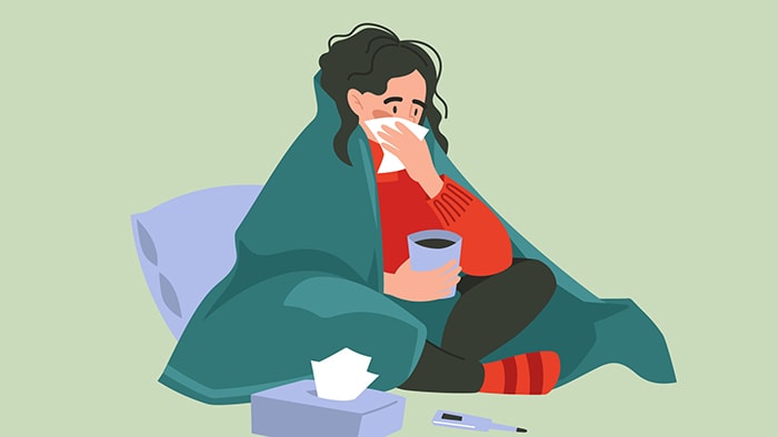 cartoon image of person with illness raising a tissue to her nose