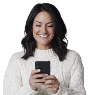 woman with white sweater smiling while looking at a cell phone