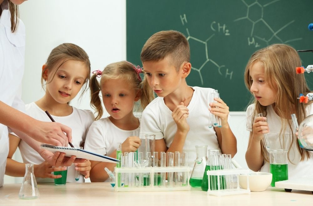 younger students working with beakers and science lesson