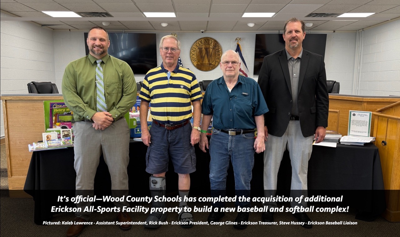 Four people pictured responsible for acquisition of new baseball and softball fields at Erickson All-Sports Facility