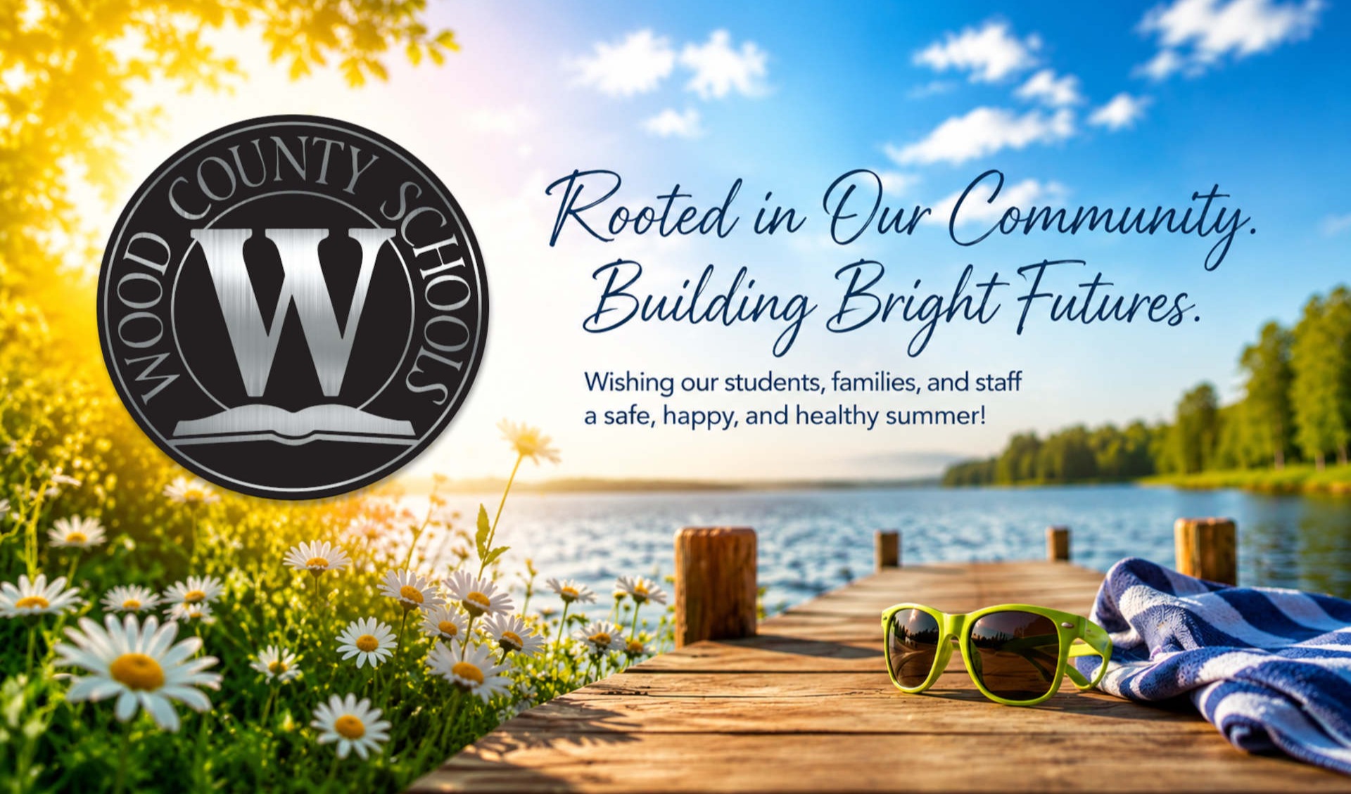 lake scene with a dock and sunglasses and beach towel - image included wood county schools logo