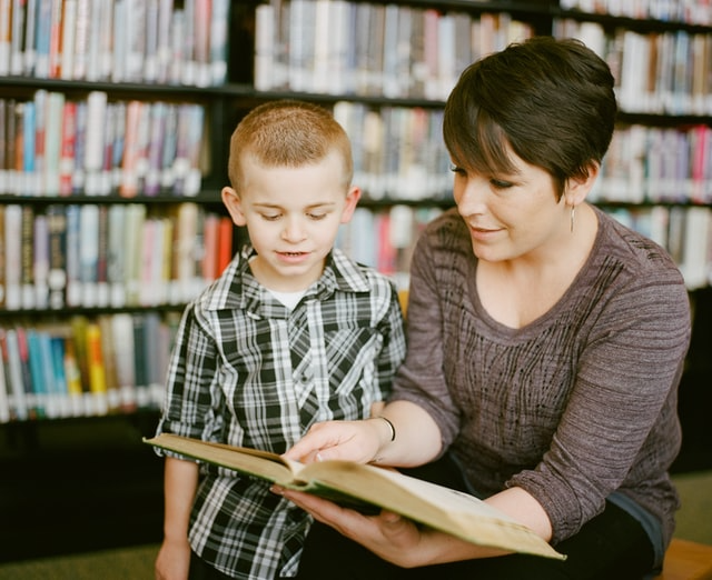 image of substitute teacher with child books in background