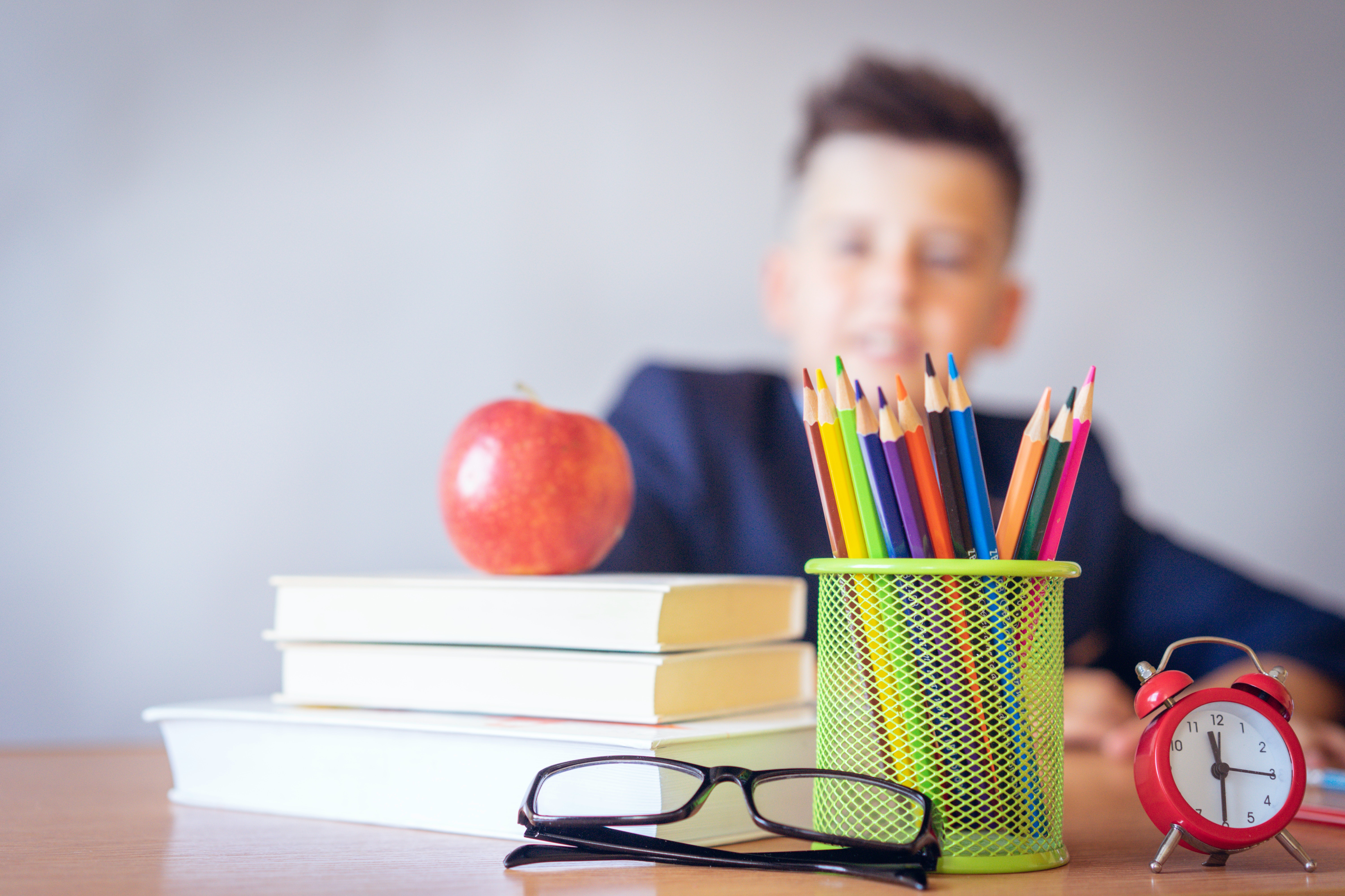 boy with books and apple
