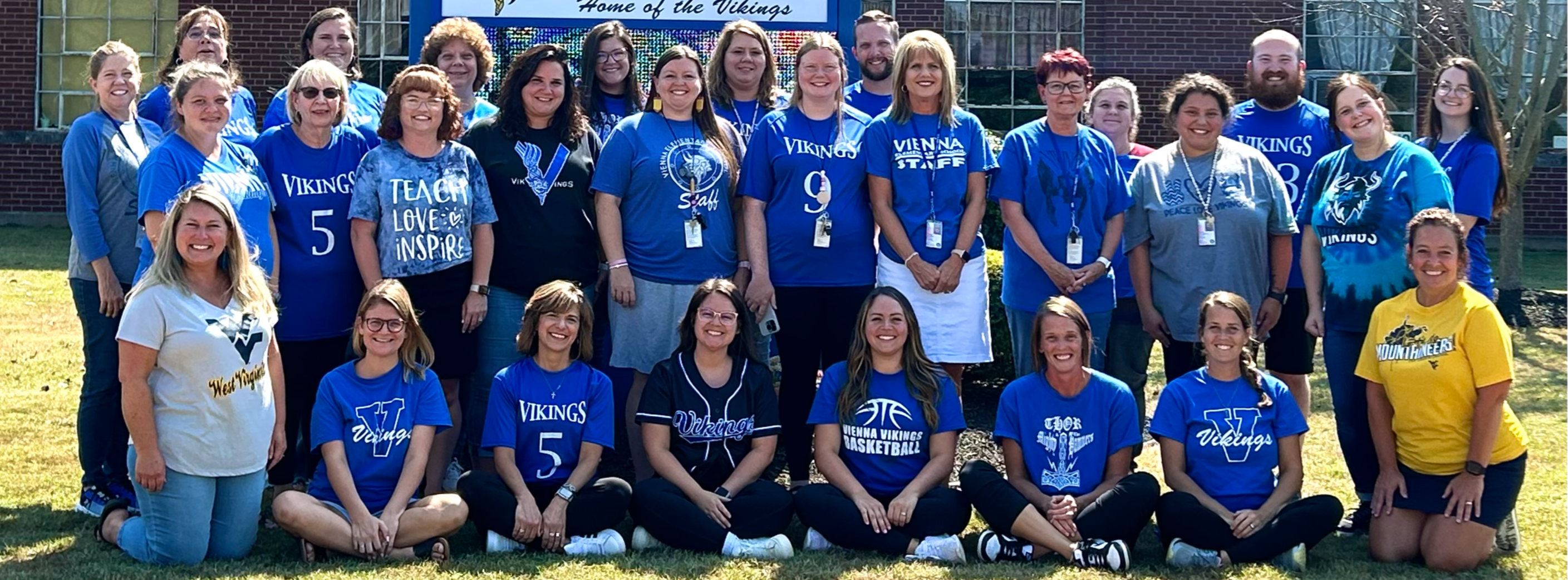 staff of vienna elementary posing outside of school buidling