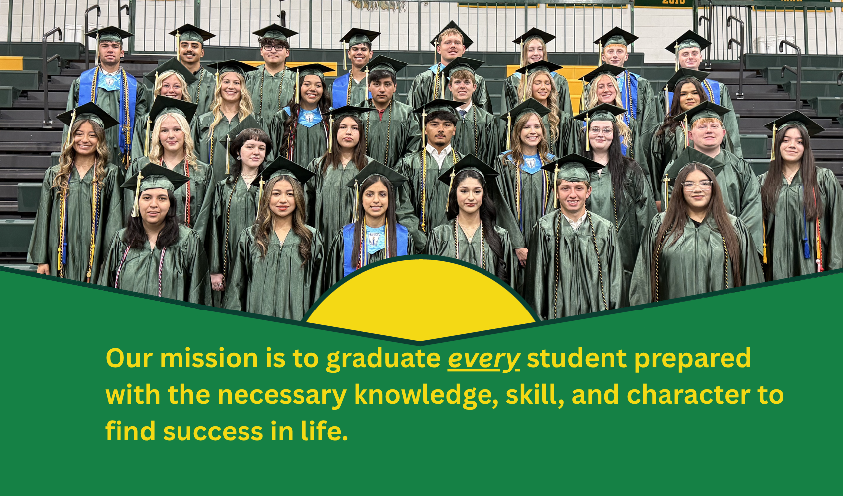 A group of graduates in green caps and gowns stands on bleachers with a green and yellow graphic in the foreground displaying text.  Transcribed Text:  Our mission is to graduate every student prepared with the necessary knowledge, skill, and character to find success in life.