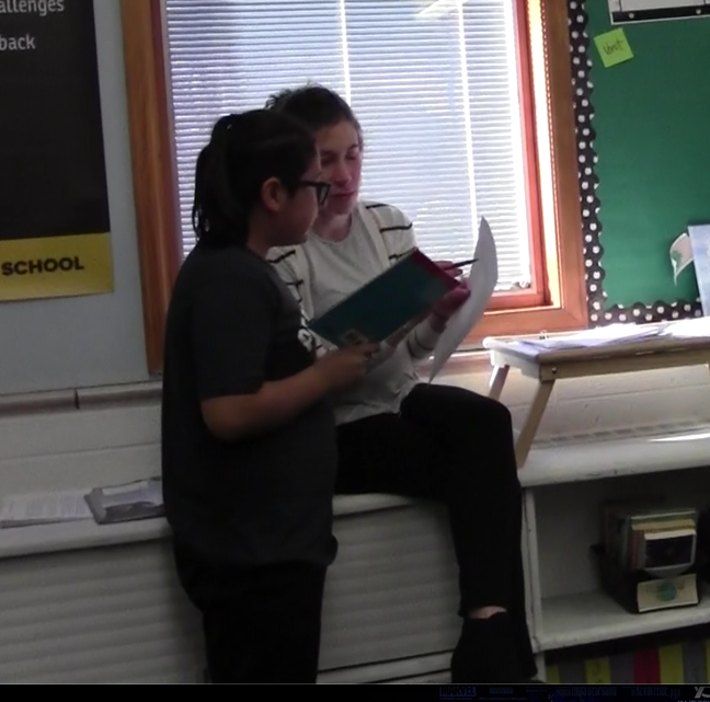 teacher reading with student
