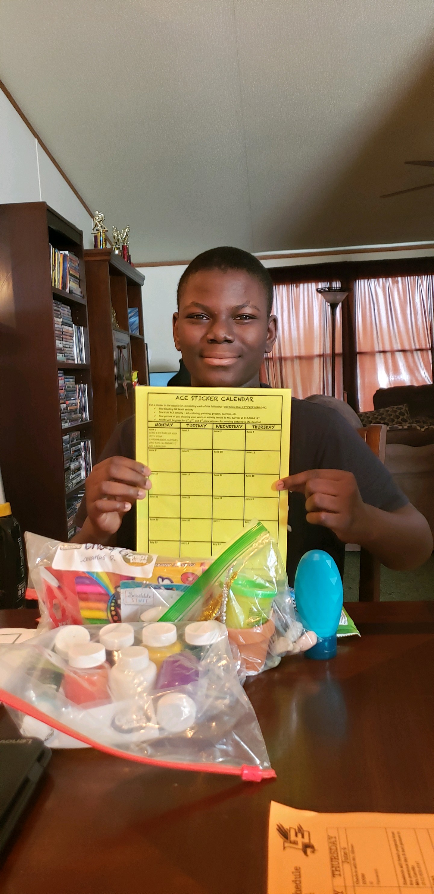 Boy with Calendar and Art Supplies