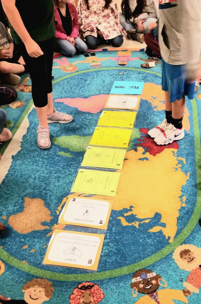 Photos of an activity called Peace Paths inside the classroom