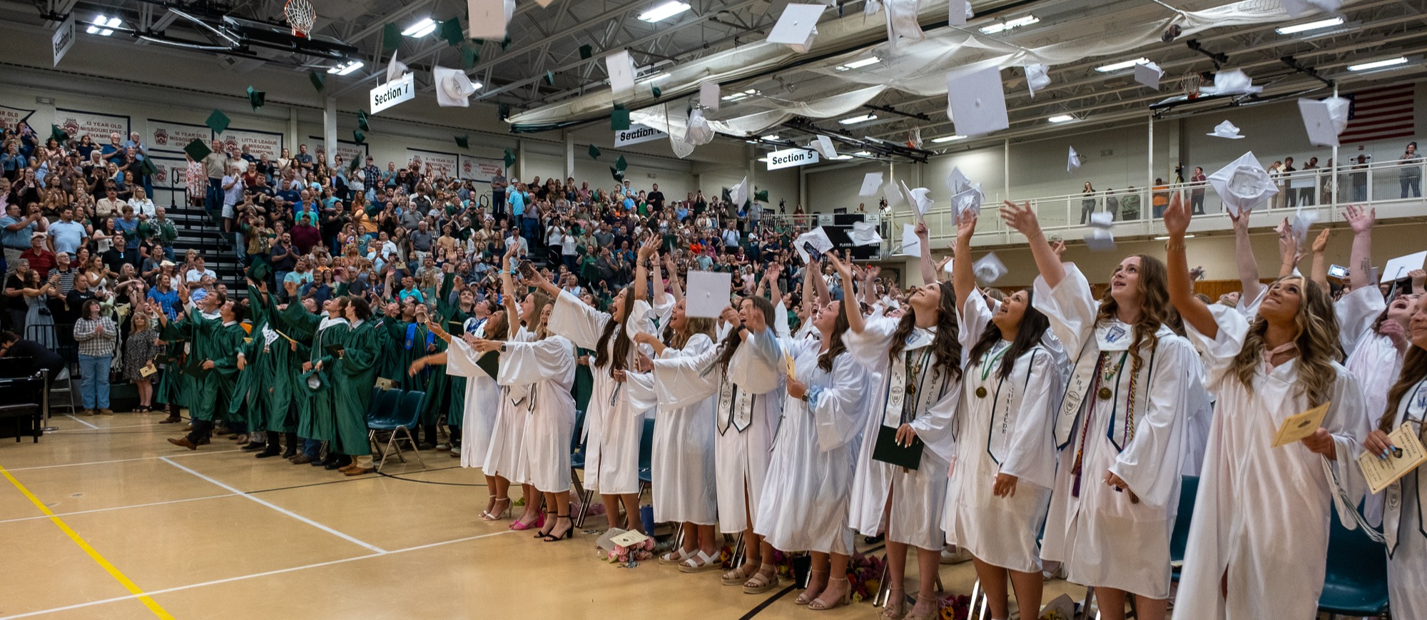 Students throw their caps following PHS graduation.