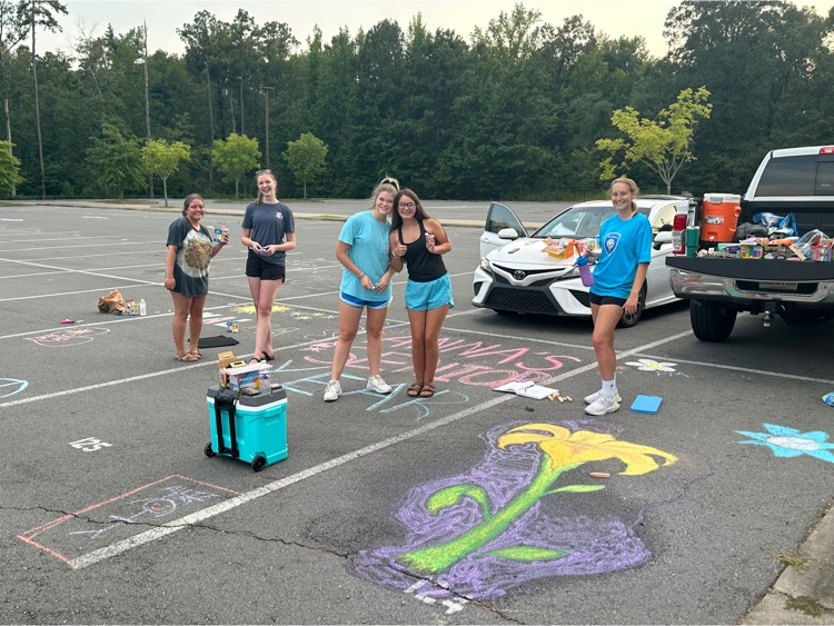 students chalking their parking spot