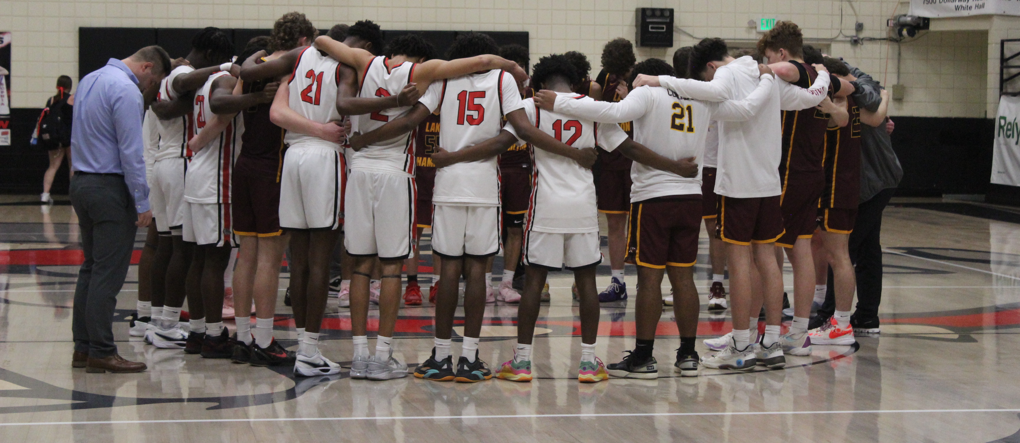 WHHS basketball team gather after the Lake Hamilton game.