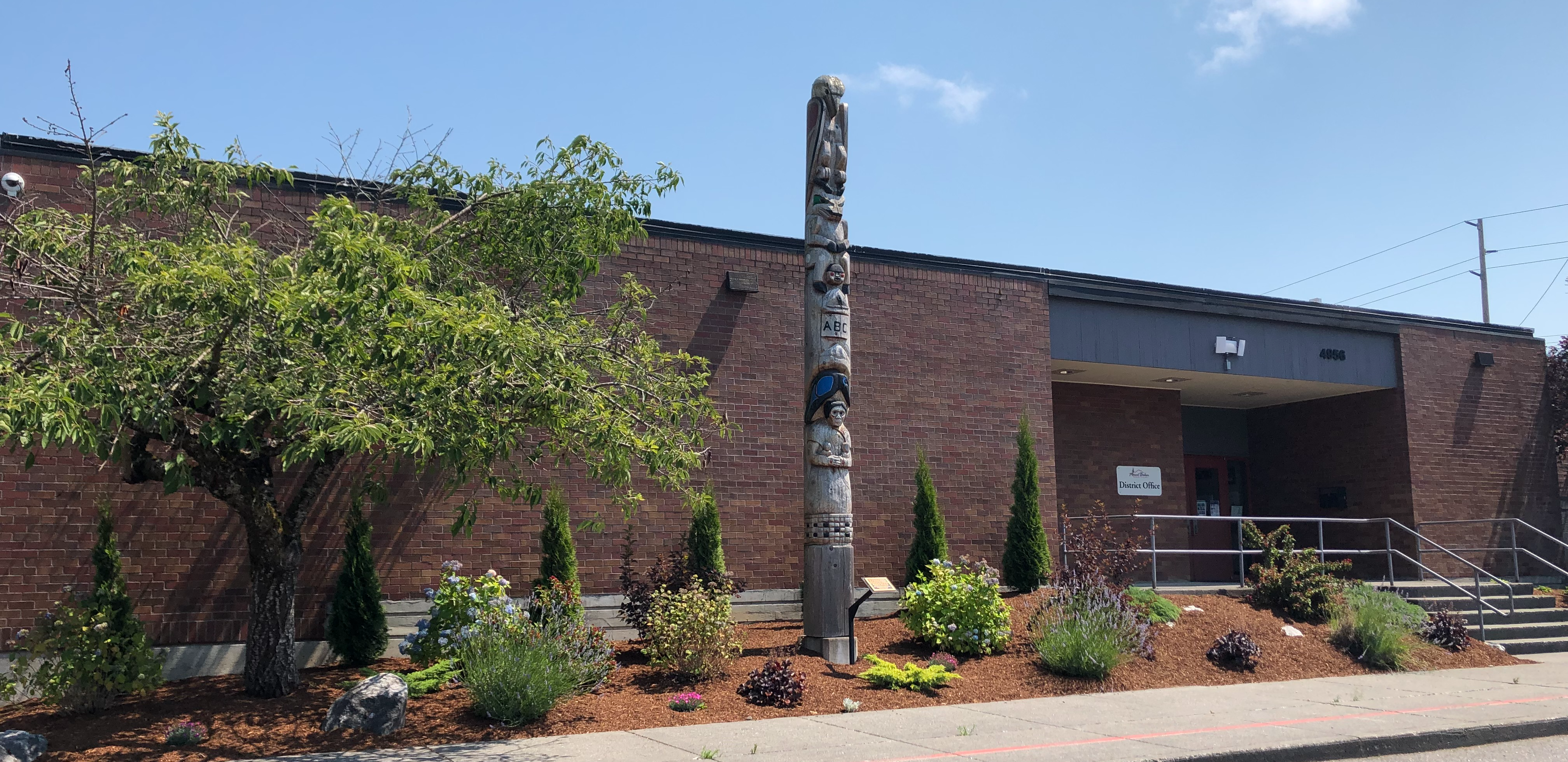 Mount Baker School District Office, Brick Building, Totem Pole, Tree, Shrubs