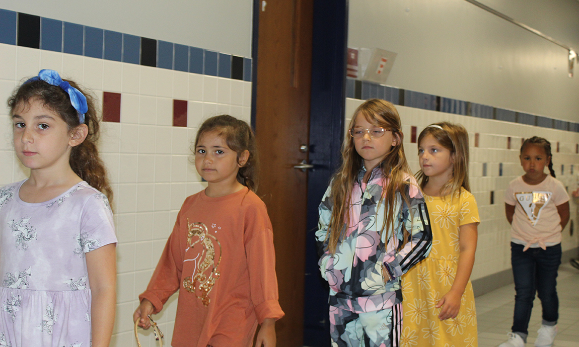 five students in hallway, lockers