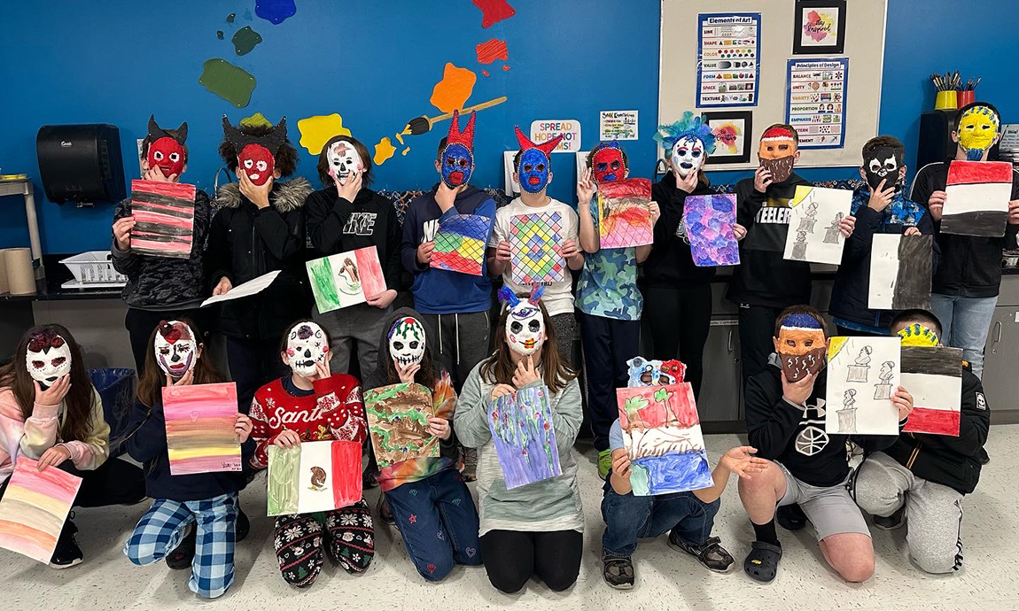 18 young stidents wearing colorful masks and holding paper flags, classroom, 