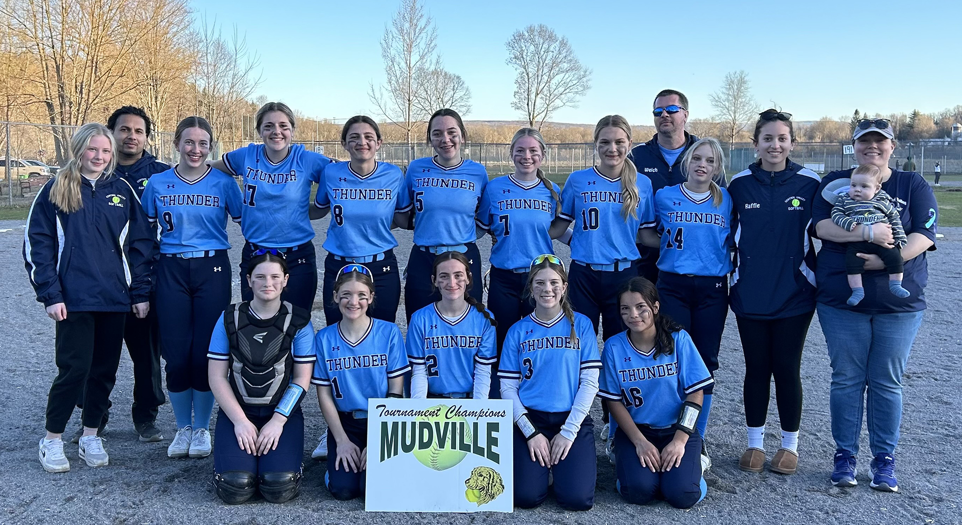 Two rows of softball players, front row sitting, back row standing, Sign saying Mudville Tournament Champions