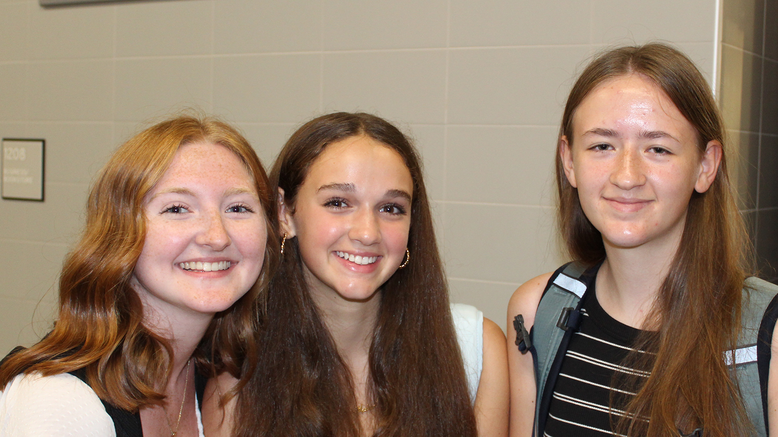 students smiling seated in cafeteria