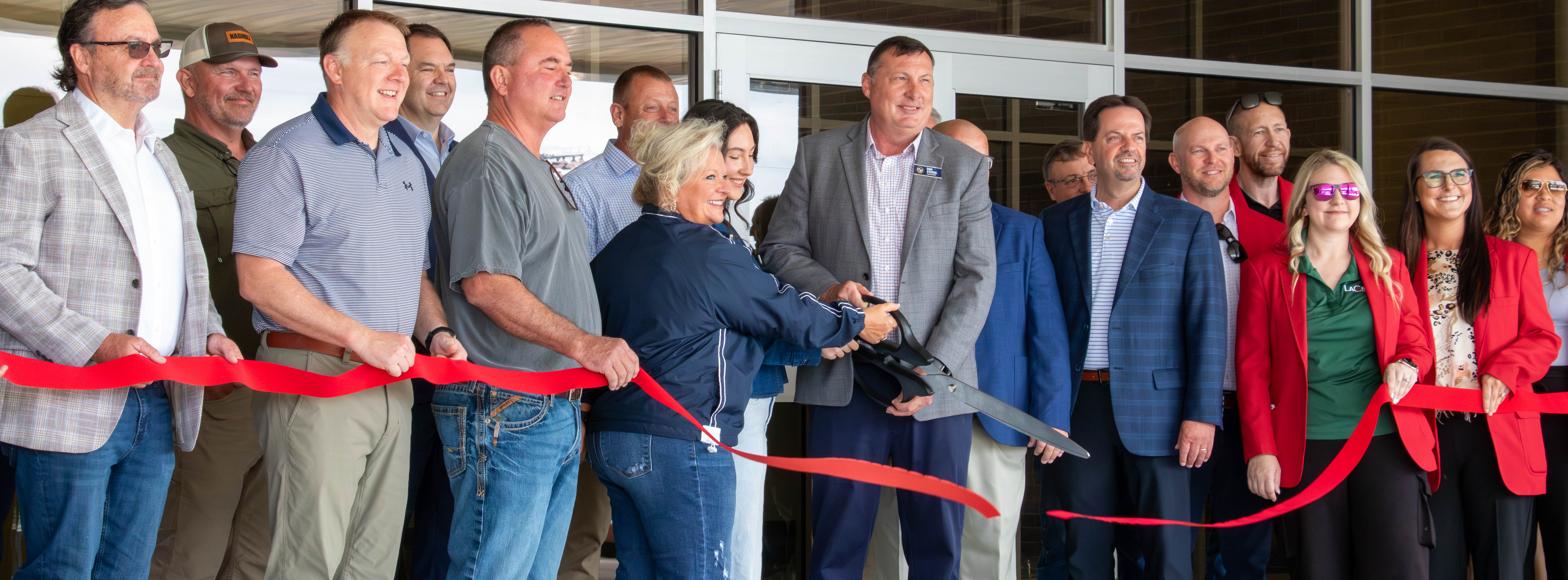 men and women at ribbon cutting