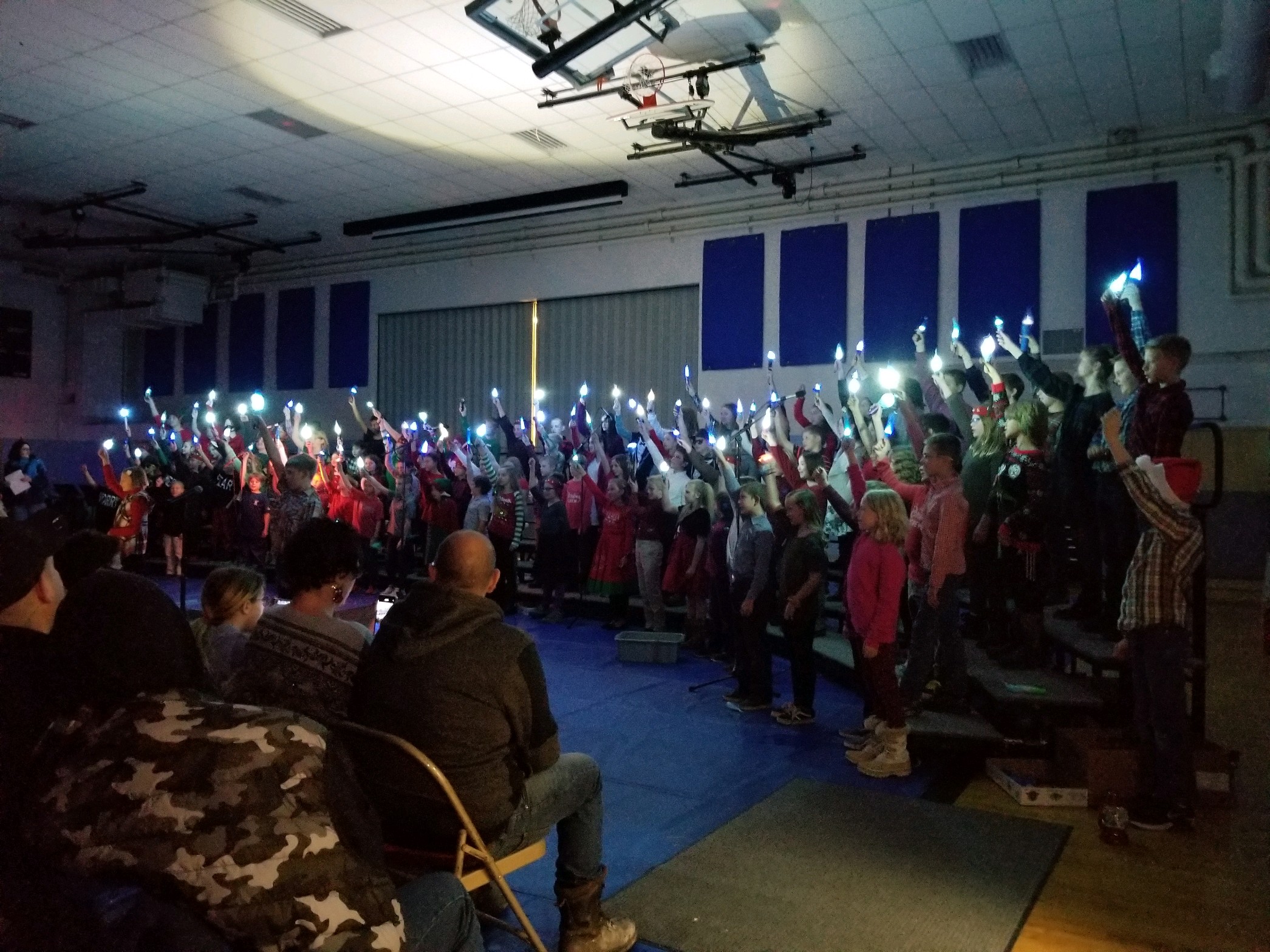 4th and 5th grade students sing Snowmaggedden with Icicle flashlights.  