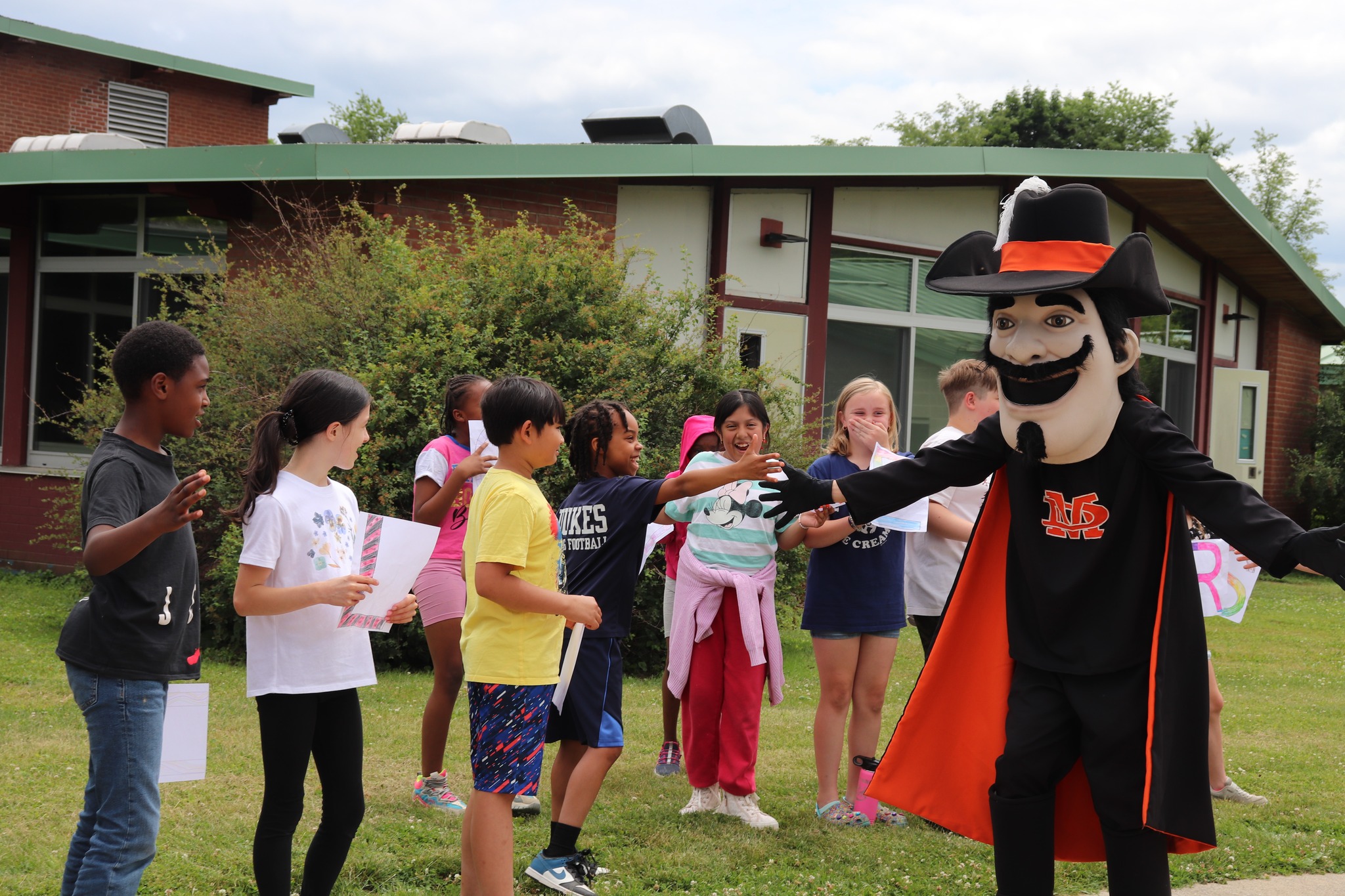 Elementary students greet the mascot