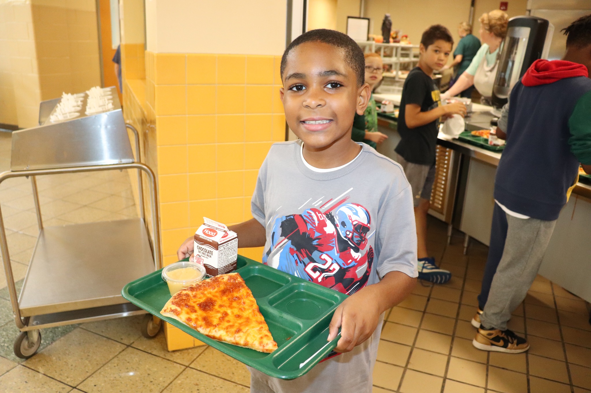 A student holding a lunch tray