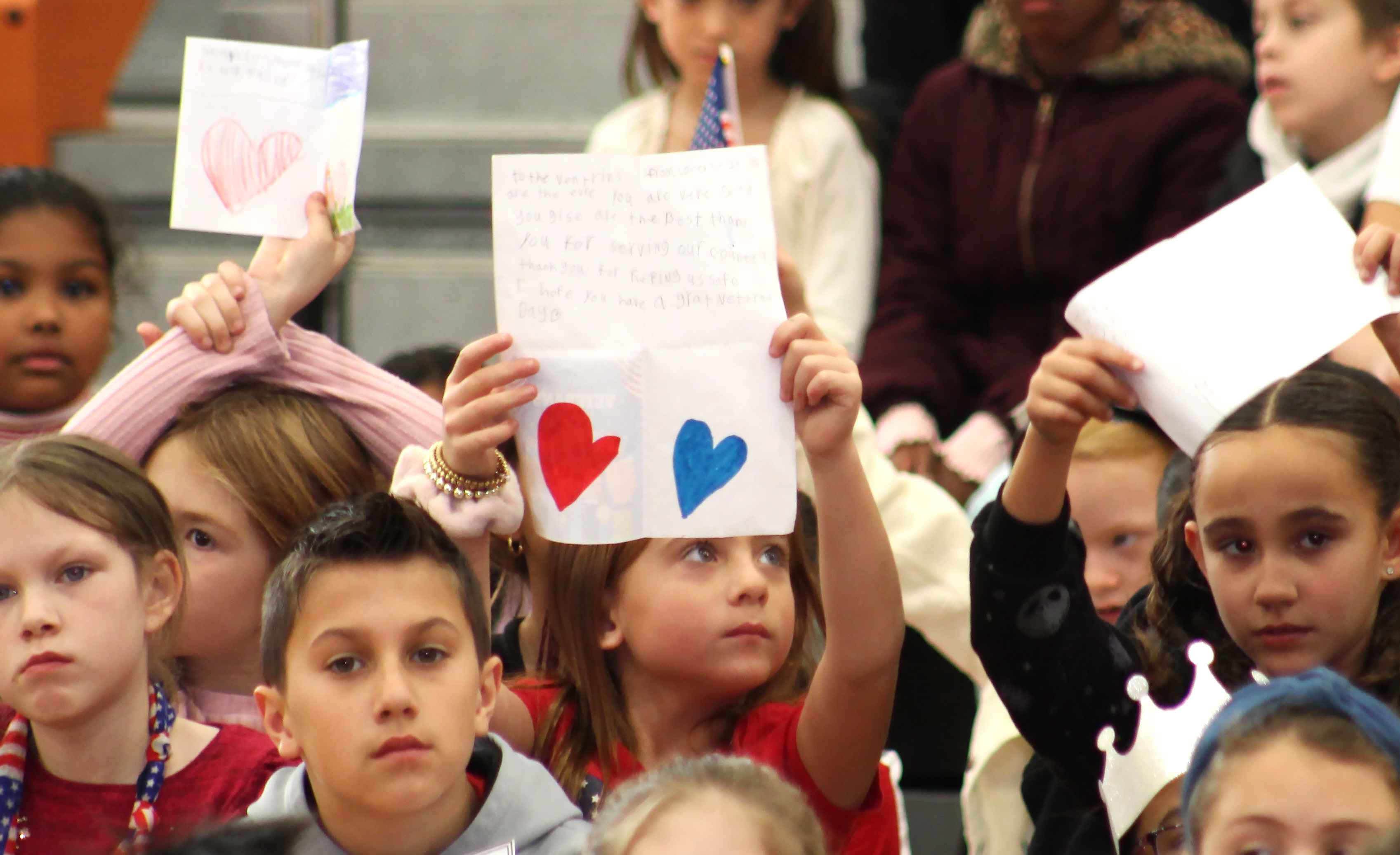 Students hold up patriotic signs