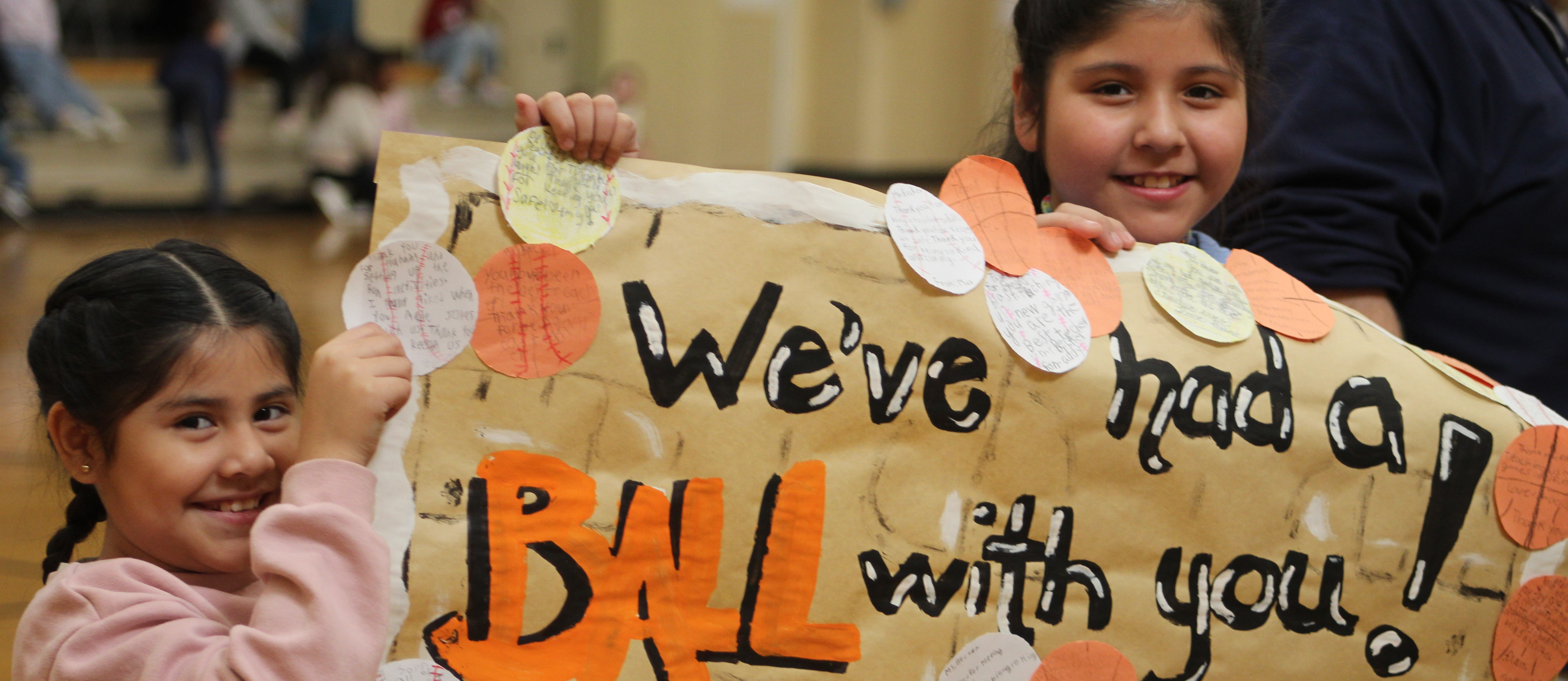 Two students holding a sign