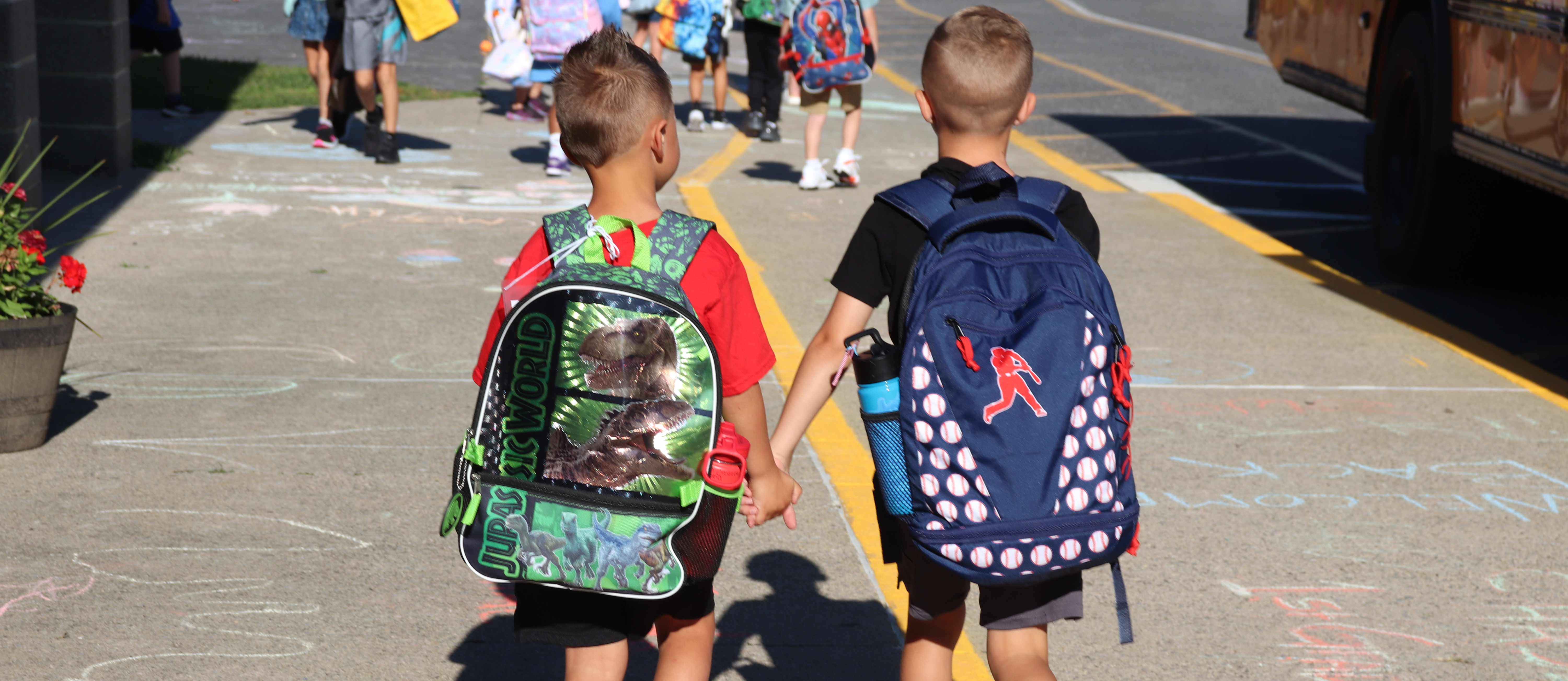 Two students walking hand in hand