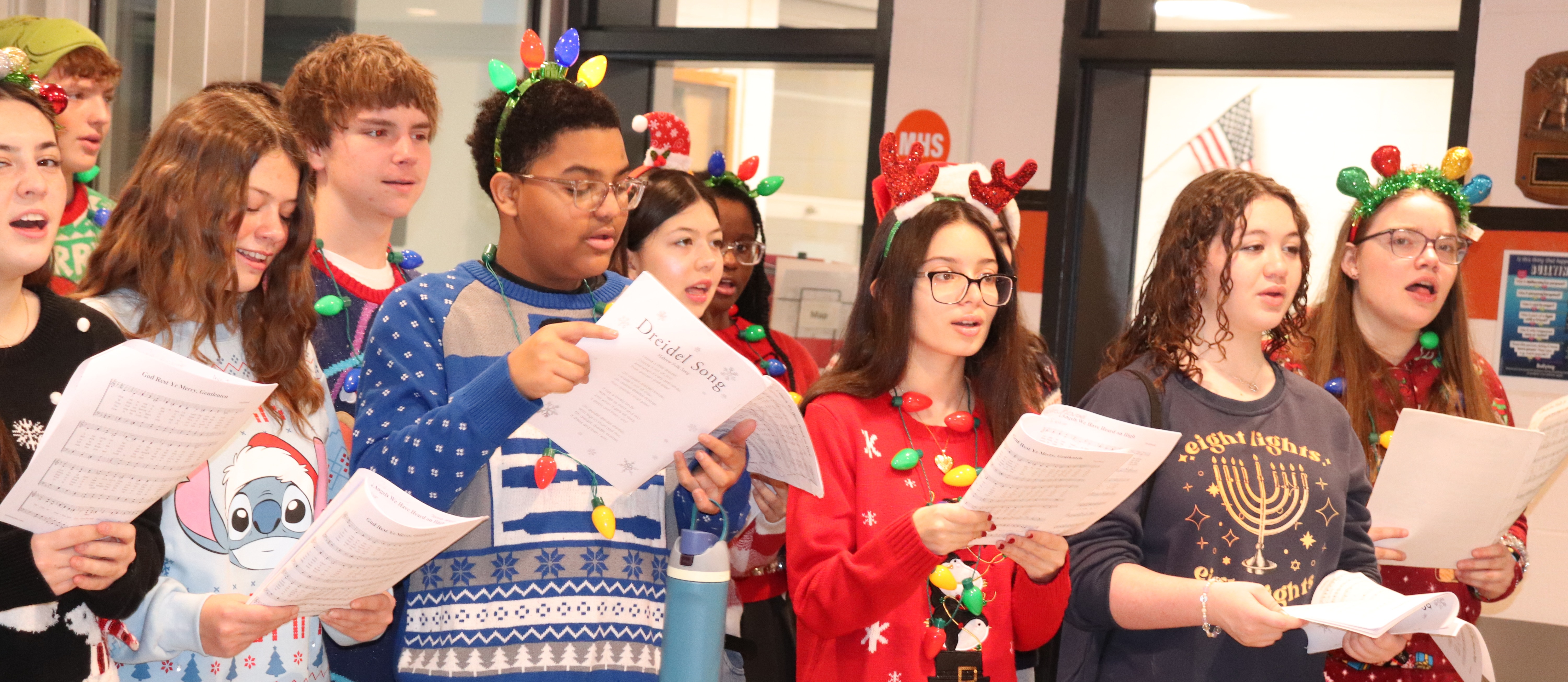 A group of high schoolers caroling