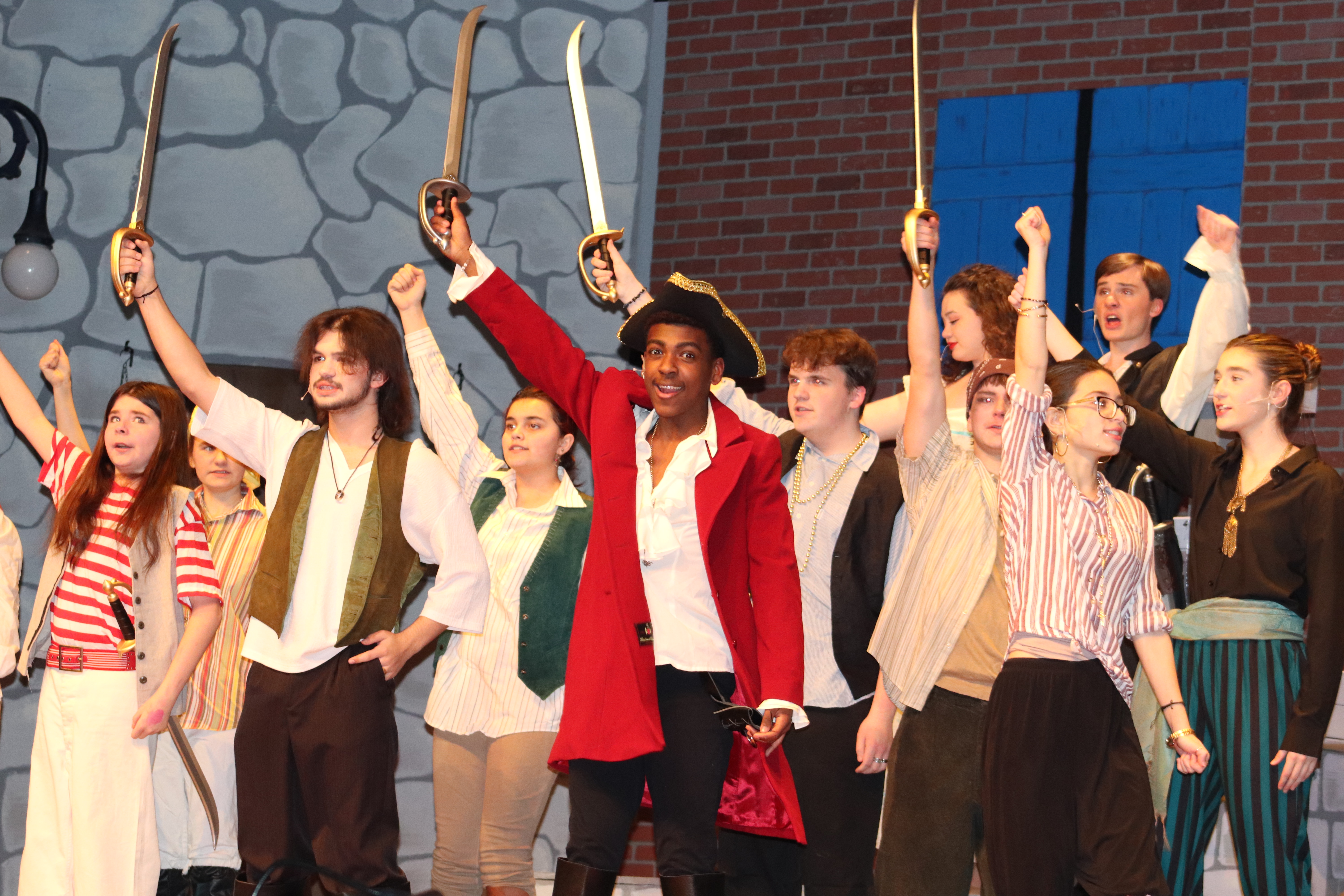 Cast members dressed as pirates on stage