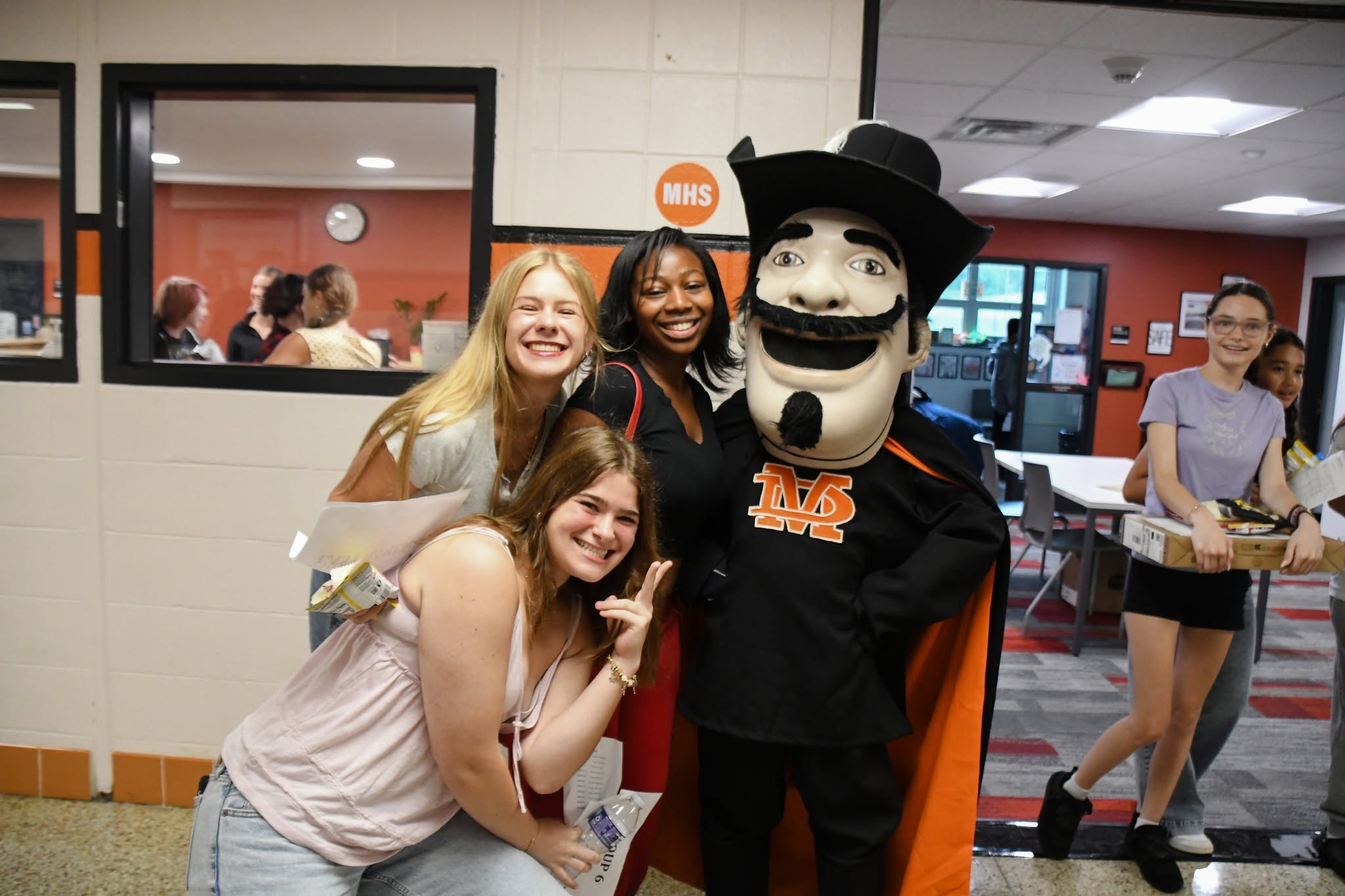 three female students with mascot