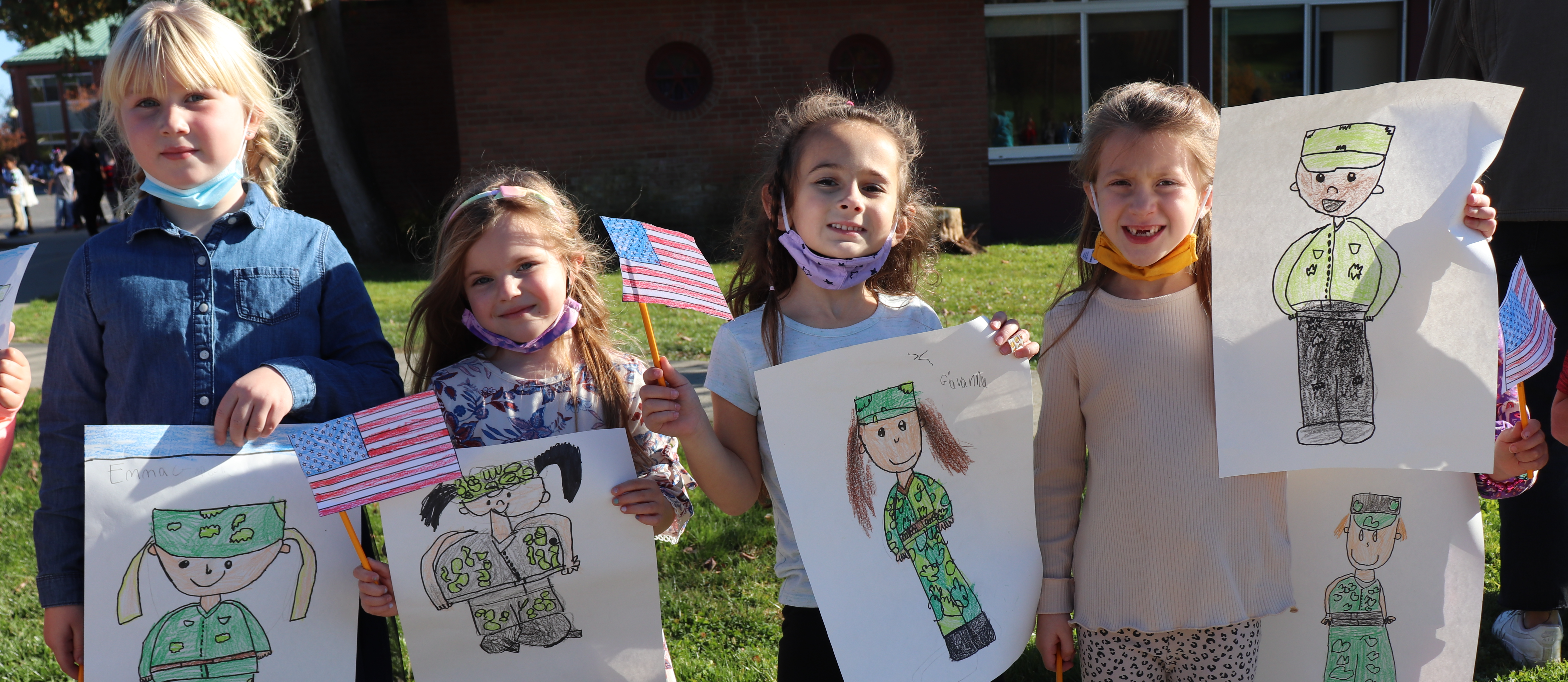 Elementary school children holding veterans day signs