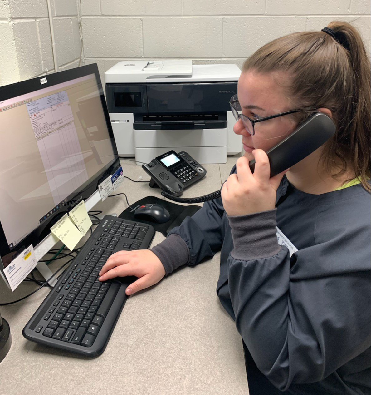 Photo of a student working the reception desk.