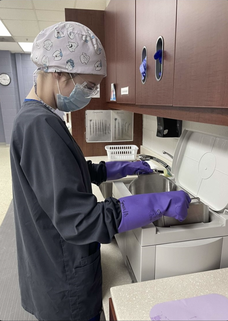 Photo of student sterilizing instruments.