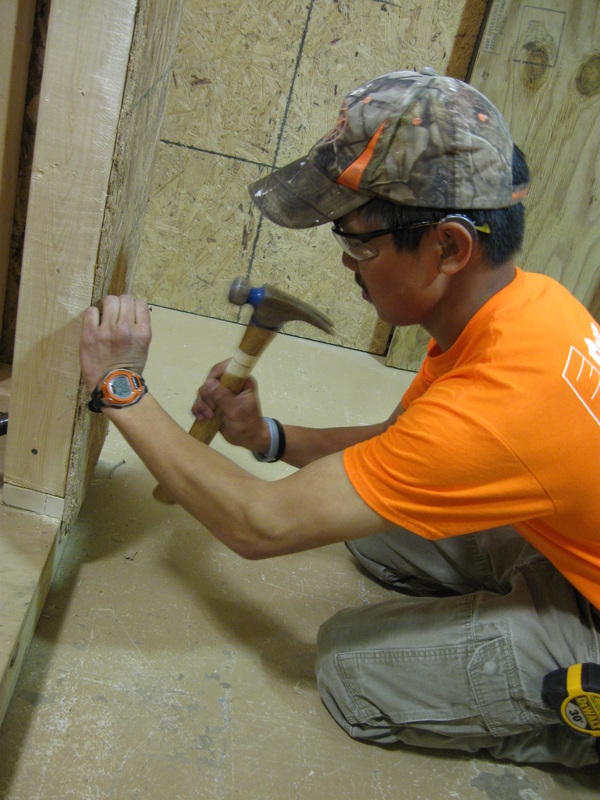 Photo of a man working in carpentry.