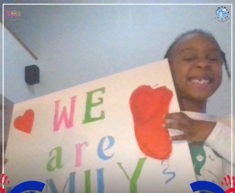 photo of child holding a sign with text and graphics of a heart