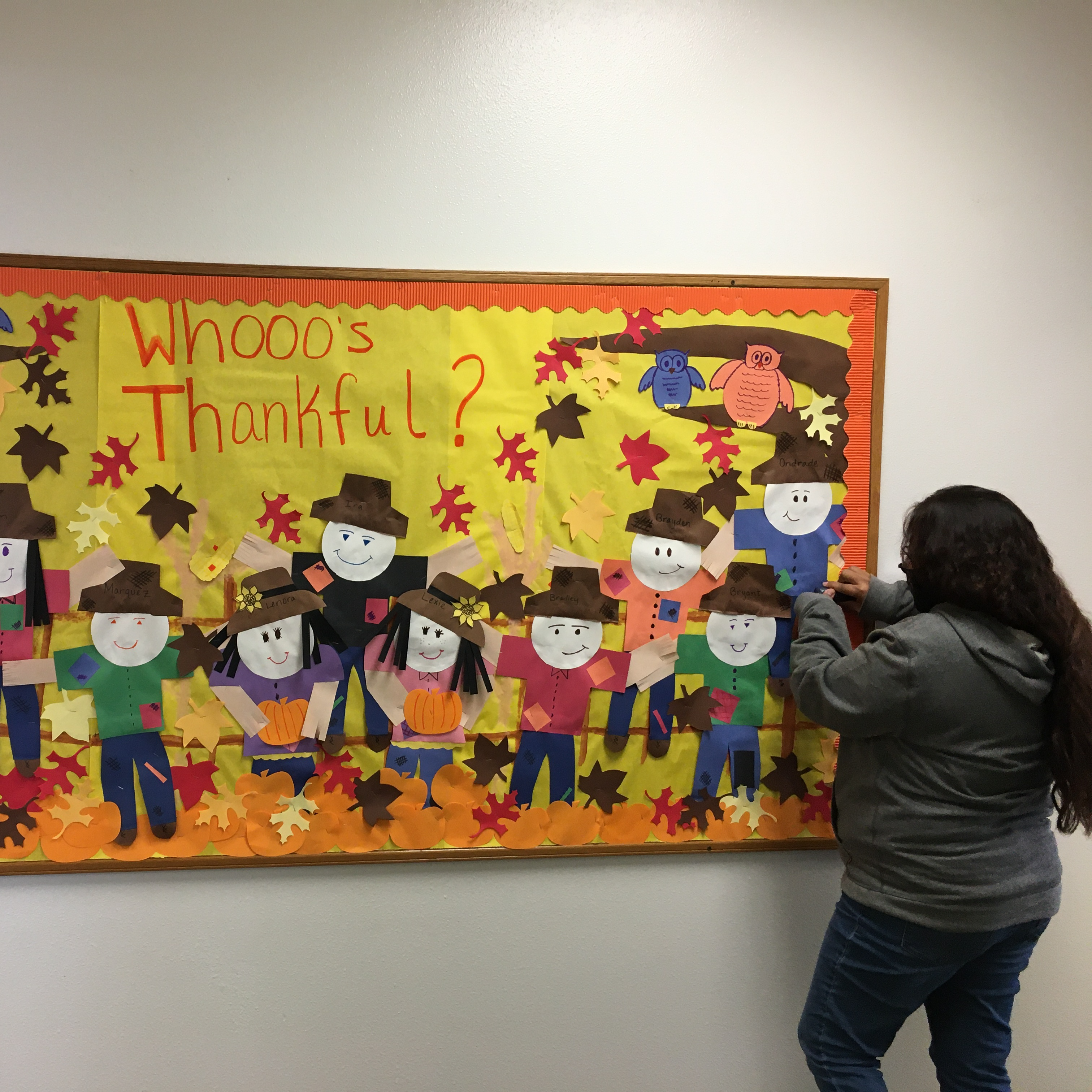 Aides creating bulletin board